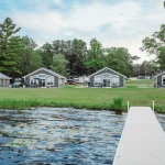 Green trees with houses and a lake